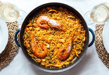 Paella típica española con mariscos, arroz y verduras.  