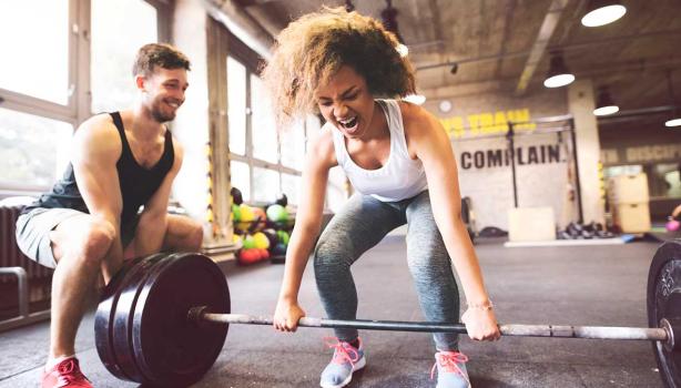 Una mujer y su entrenador haciendo entrenamientos de fuerza