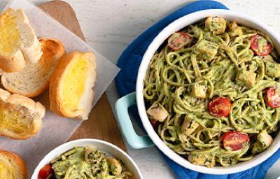 Pasta pesto con tomate cherry y queso, acompañado de pan tostado con mantequilla Pasta pesto con tomate cherry y queso, acompañado de pan tostado con mantequilla