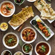 Diversas comidas indias como pan naan, lassi, tikka masala y dhal 